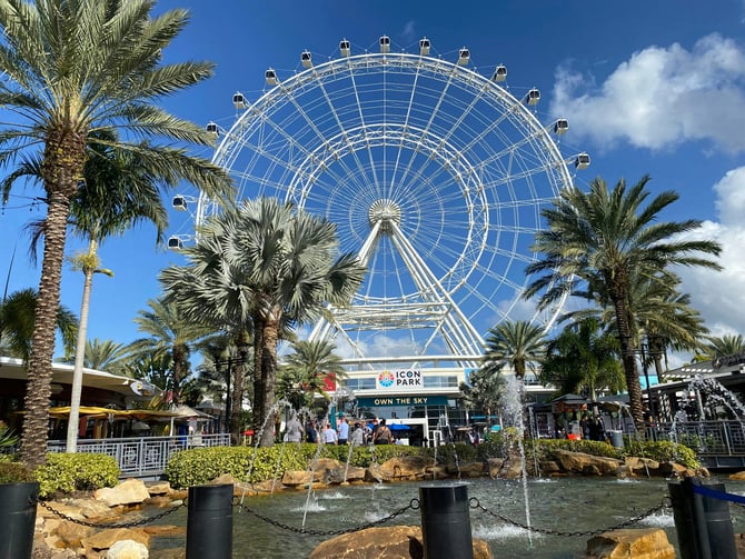 The Wheel at ICON Park rising above palm trees in Orlando